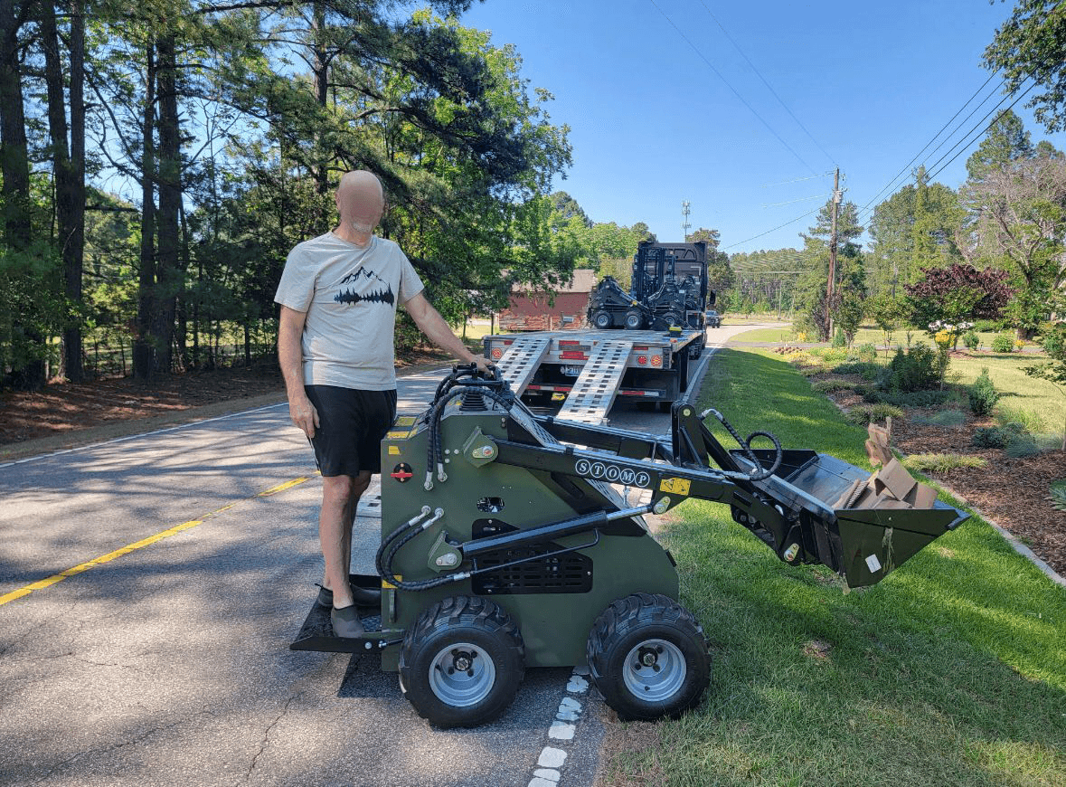 Customer beside TYPHON STOMP compact loader